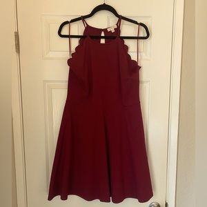 Red dress with unique neckline and cutout in the back.